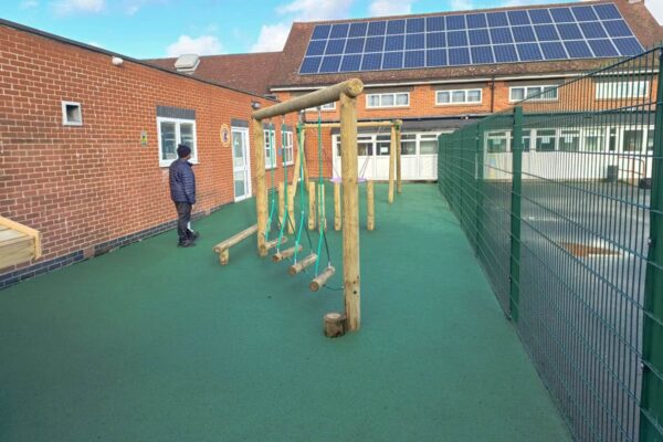 Trim trail with log traverse on green surfacing