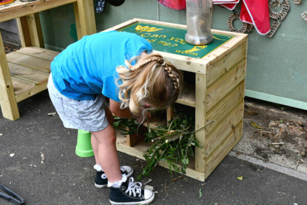 SS1 3BS-7001-Nursery Shoot-Bug Hotel-2-EDIT-WEB children play bug hotel in the background