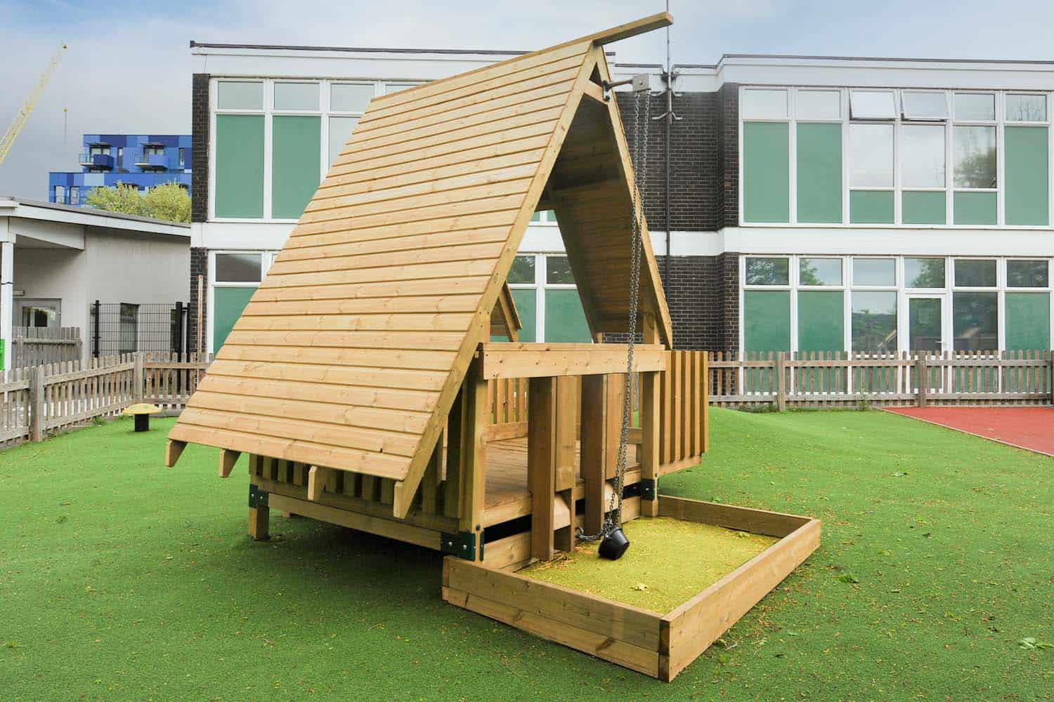 a wooden hut with a sand pit